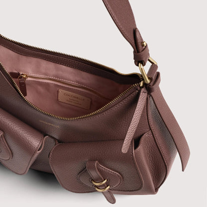 Італійська шкіряна жіноча сумка Coccinelle Mavery Pocket Medium E1 VGK 12 01 01 R49 кольору бургунді